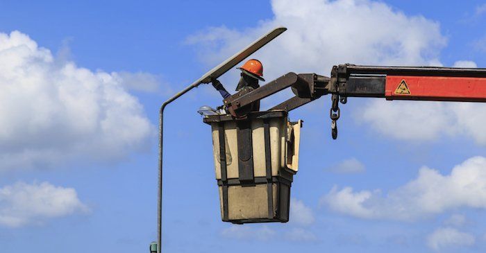 man lifted up with crane
