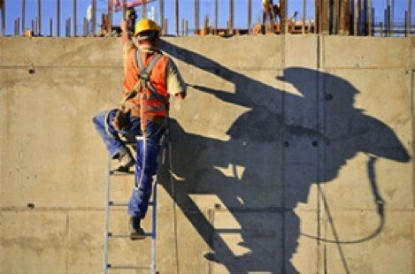 man climbing construction wall