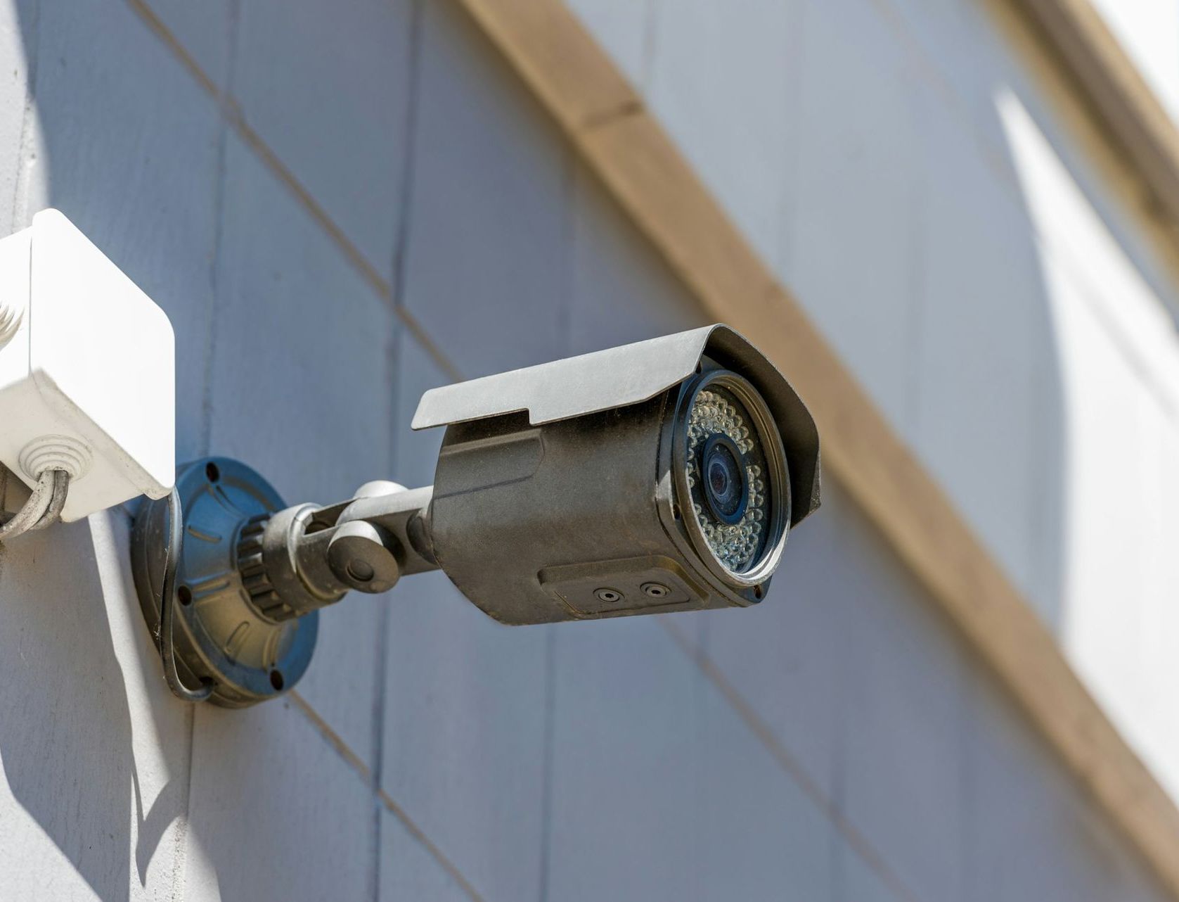 Security Camera Mounted on a Light-colored Building Wall — Stewys Electrical and Communications In Tweed Heads, NSW