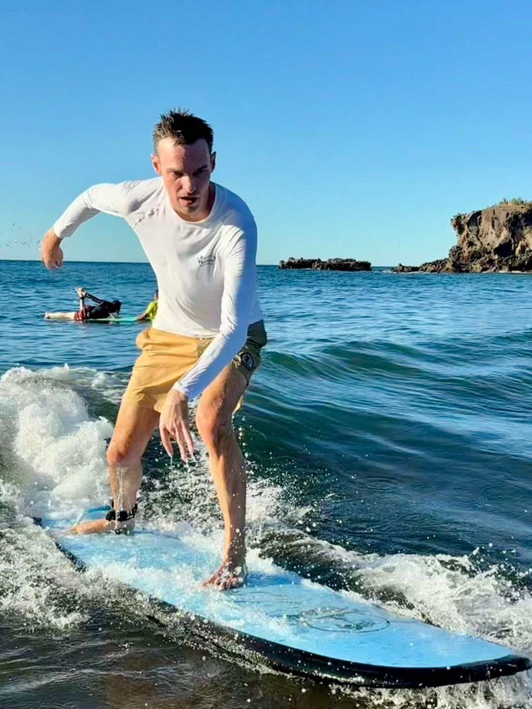 A man is riding a wave on a surfboard in the ocean.
