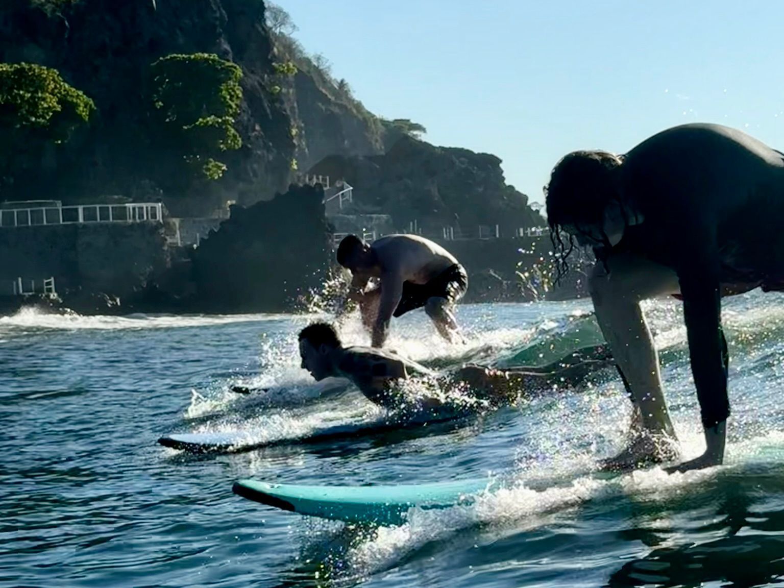 Two people are riding waves on surfboards in the ocean