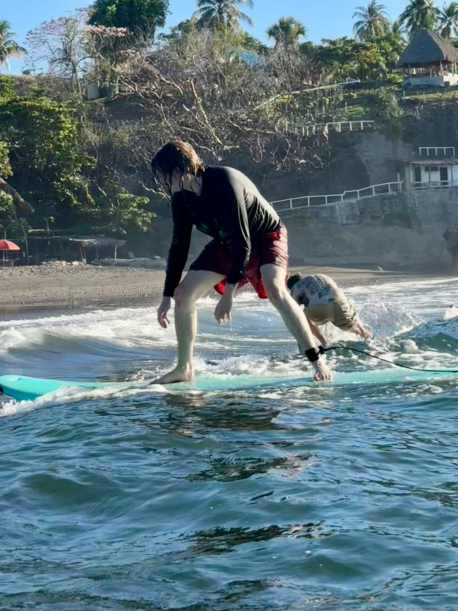 A man is riding a wave on a surfboard in the ocean.