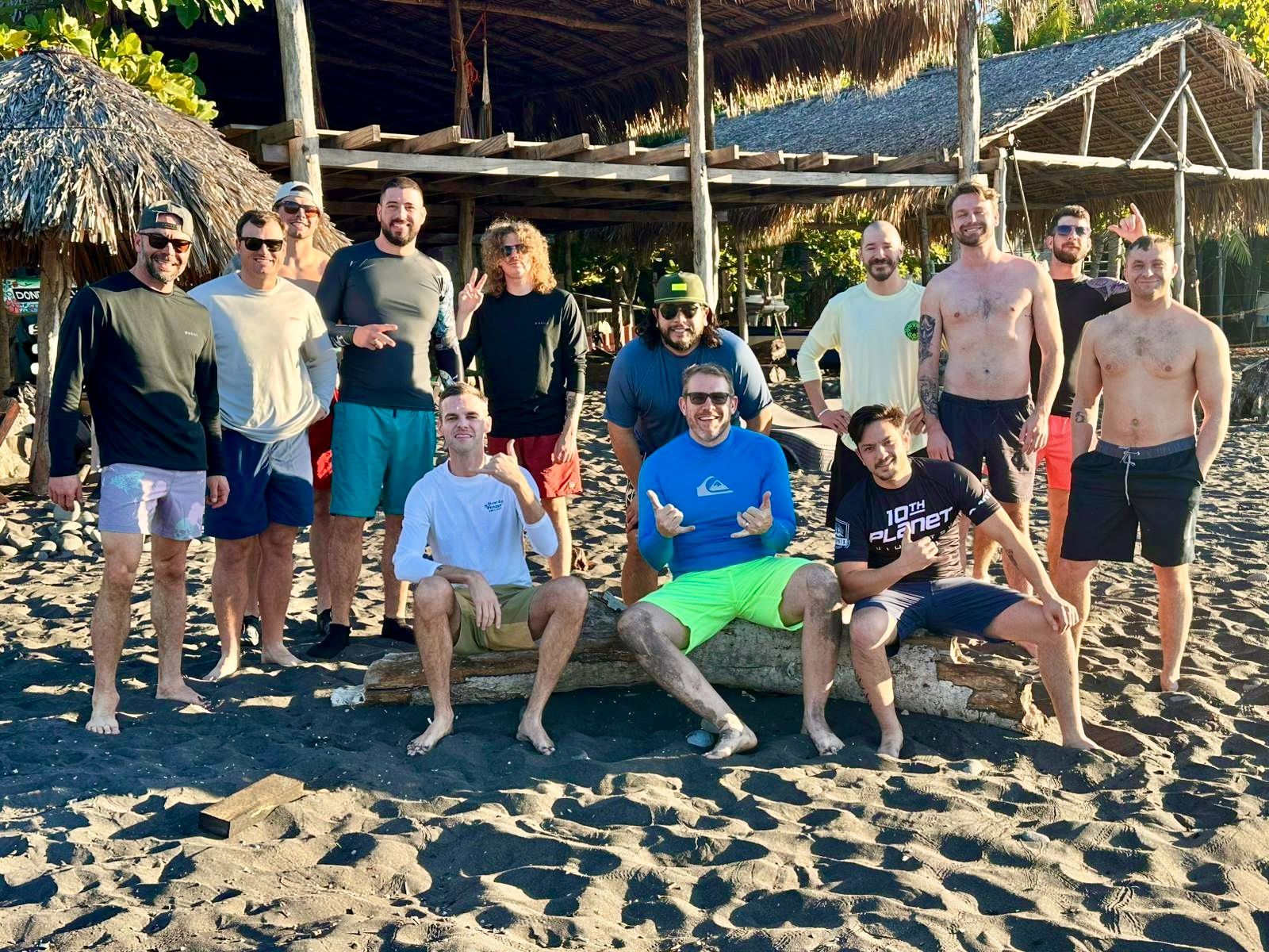 A group of people are posing for a picture on the beach.