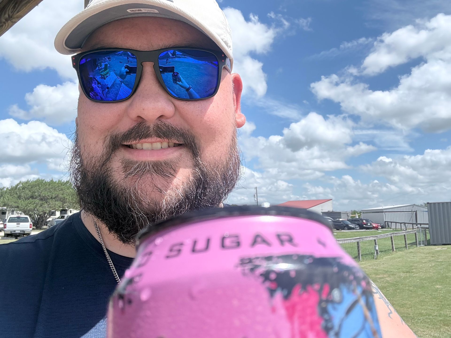 A man with a beard and a beanie is smiling for the camera.
