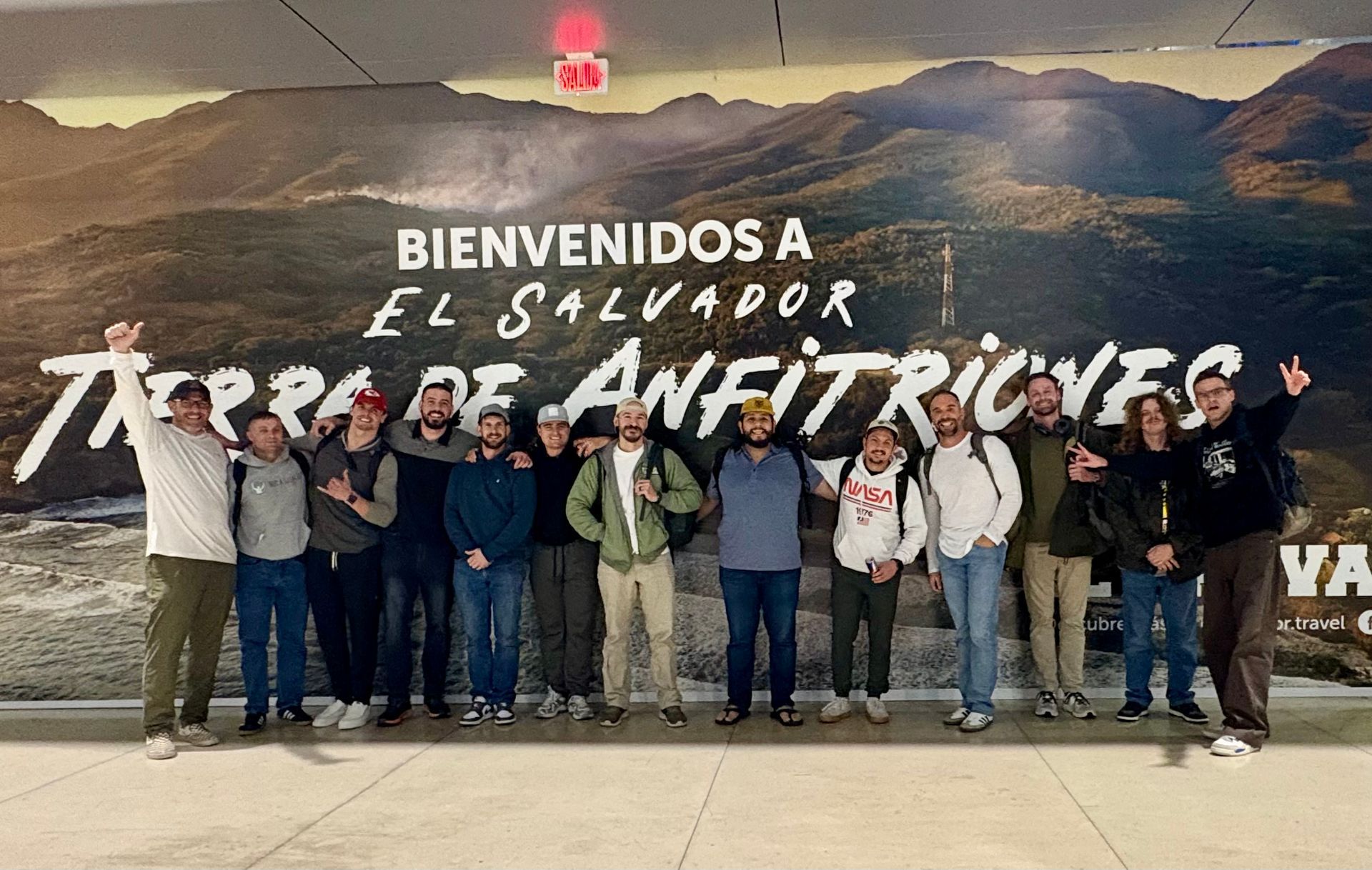 A group of men are standing around a table holding bags of meat.