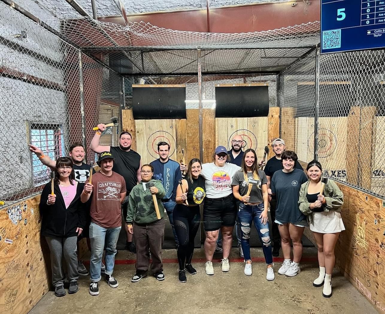 A group of people are standing on top of a boat in the water.