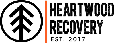 The heartwood recovery logo is black and orange and says heartwood recovery est . 2017.
