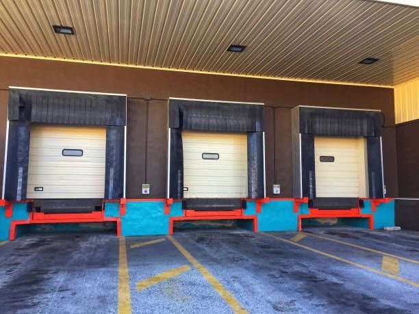 A row of loading docks in a parking lot.