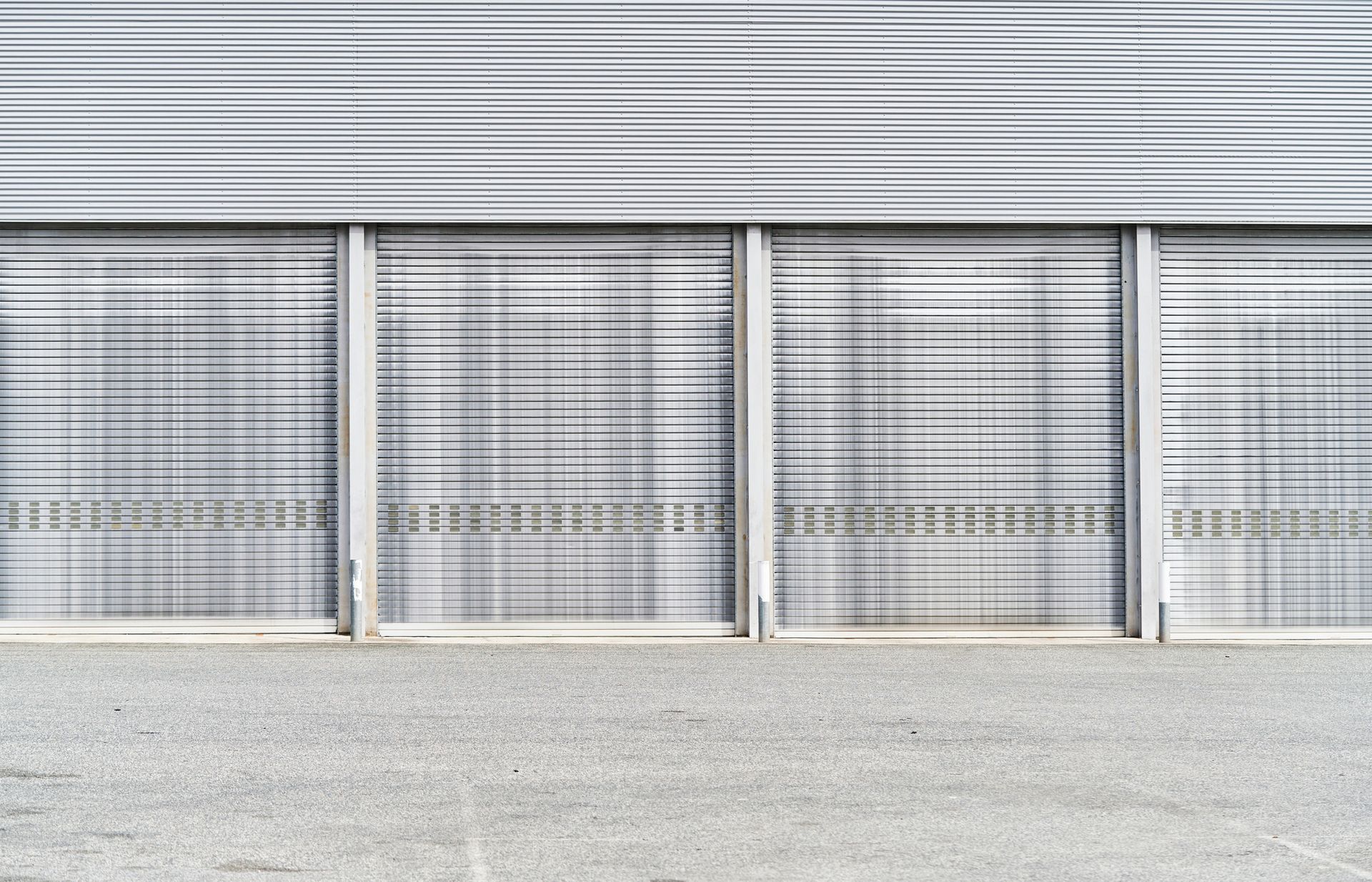 A row of garage doors on the side of a building.