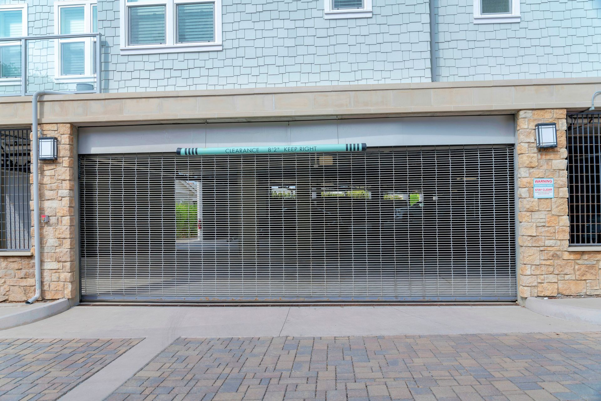 A blue room with a brick wall and a metal gate.