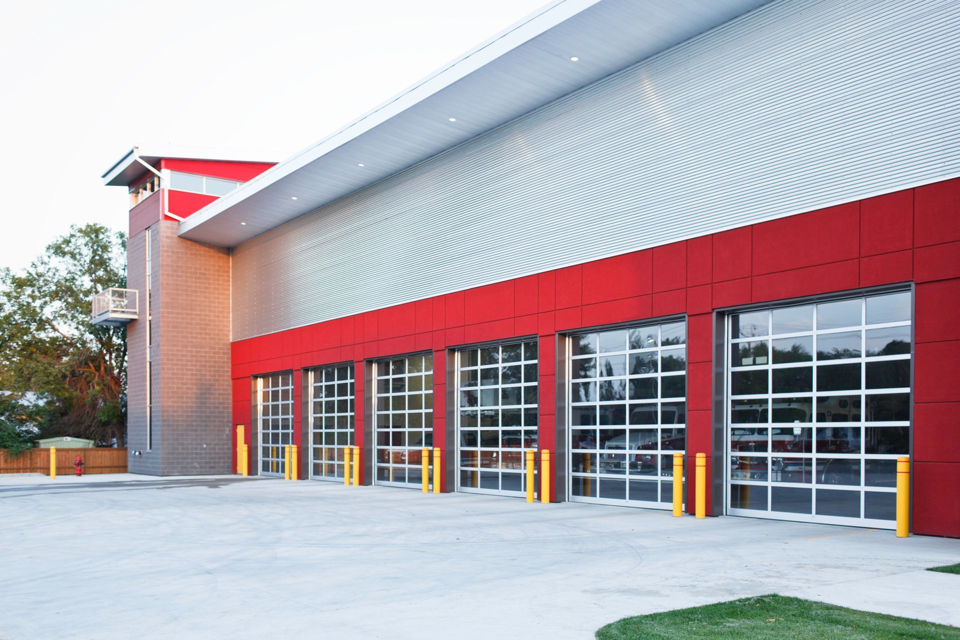 A red and silver building with a lot of garage doors.