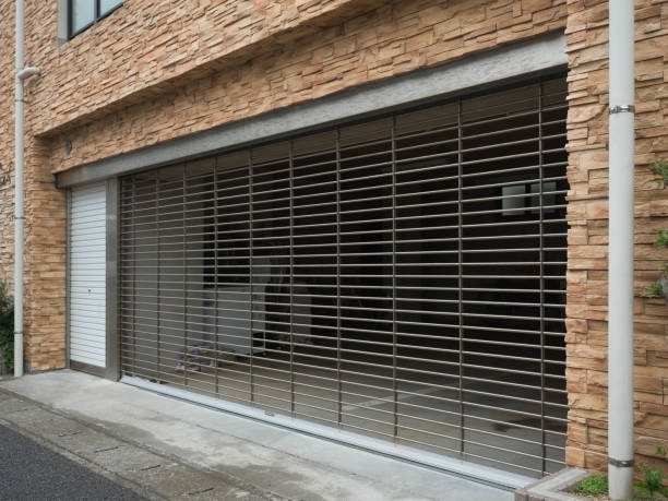 A brick building with a stainless steel garage door.