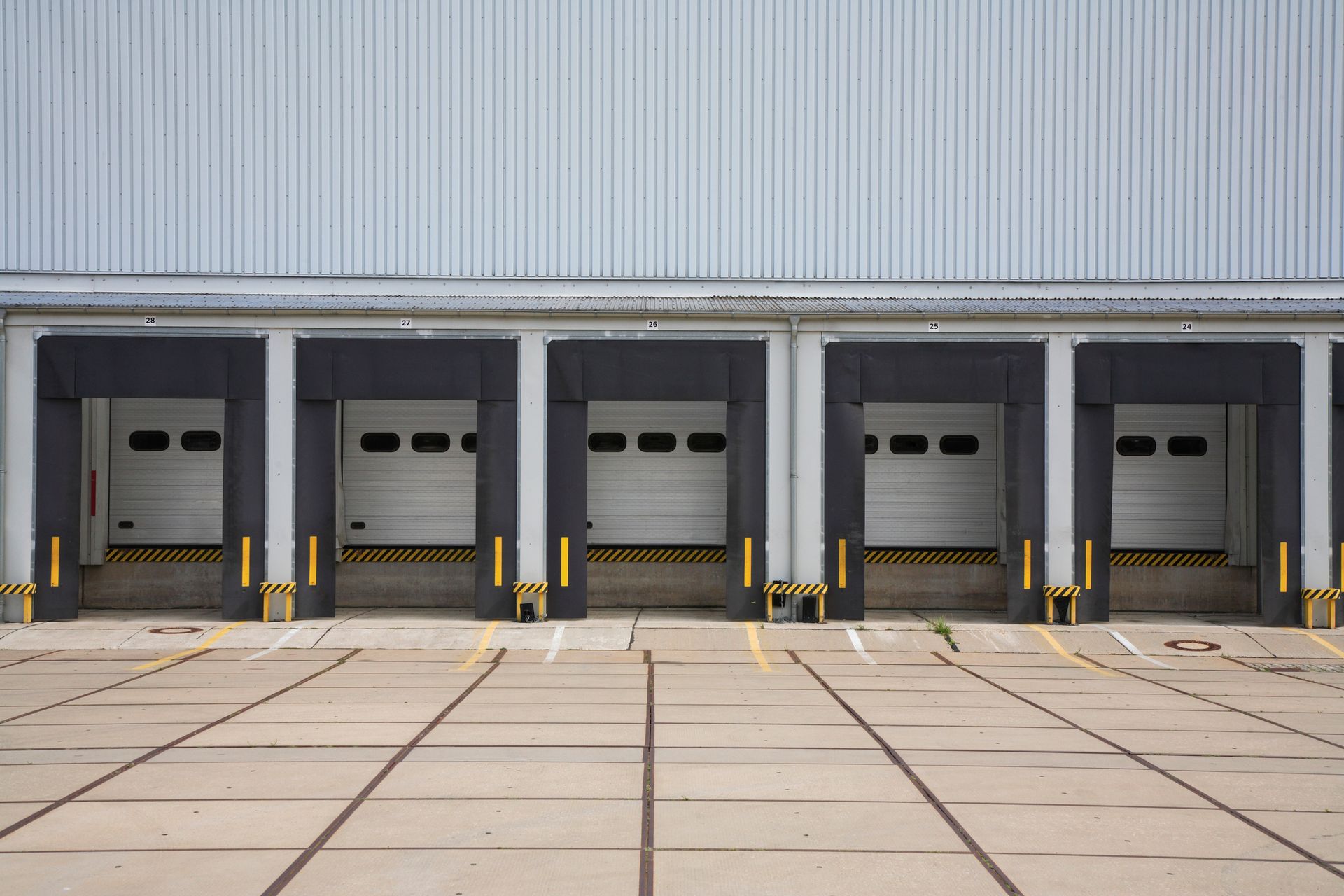 A row of loading docks in front of a warehouse.