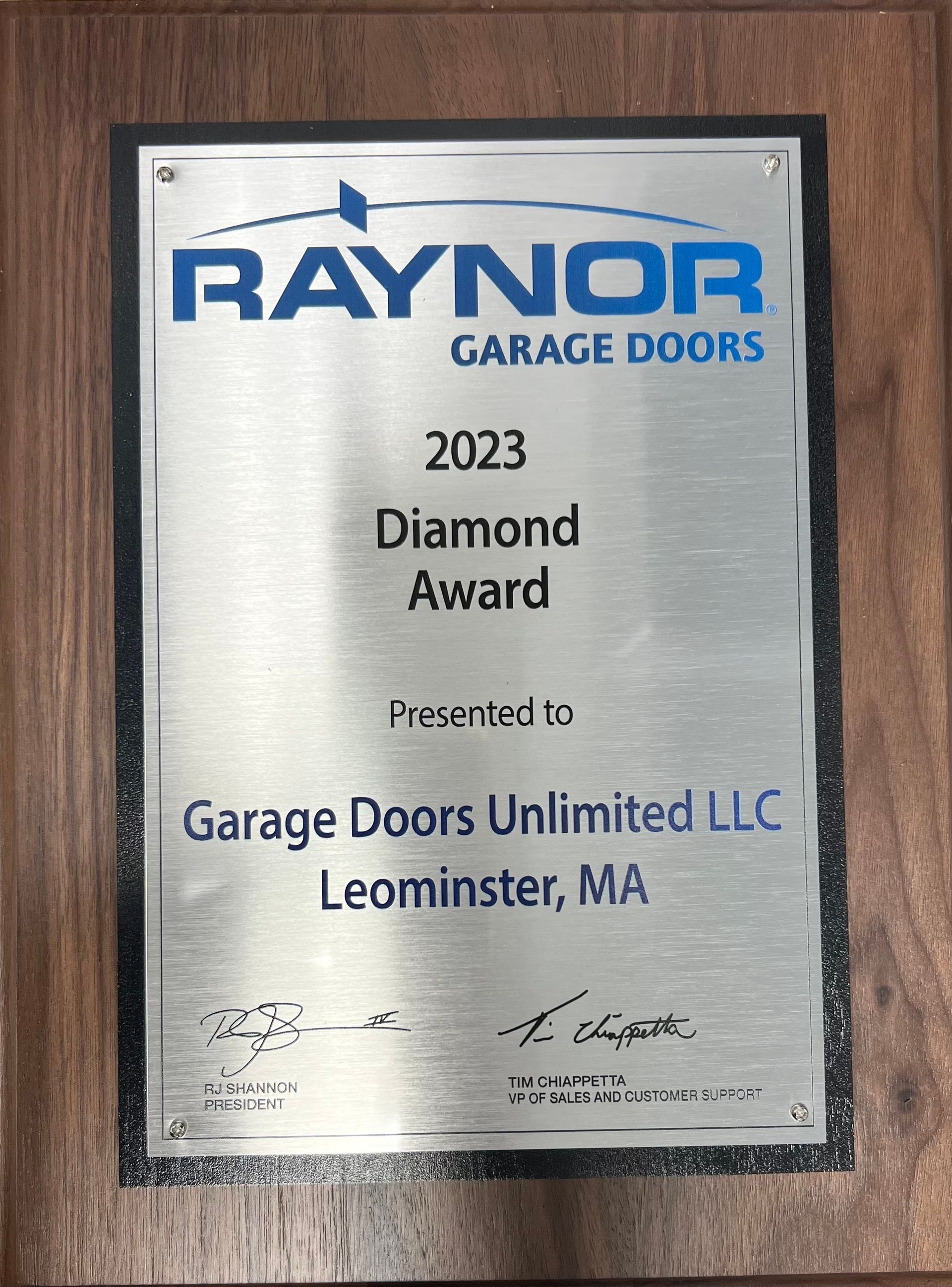 A plaque that says Raynor Garage Doors on it.