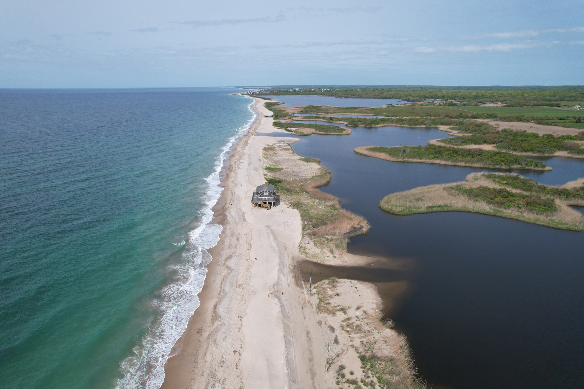 An aerial view of a beach with a car on it