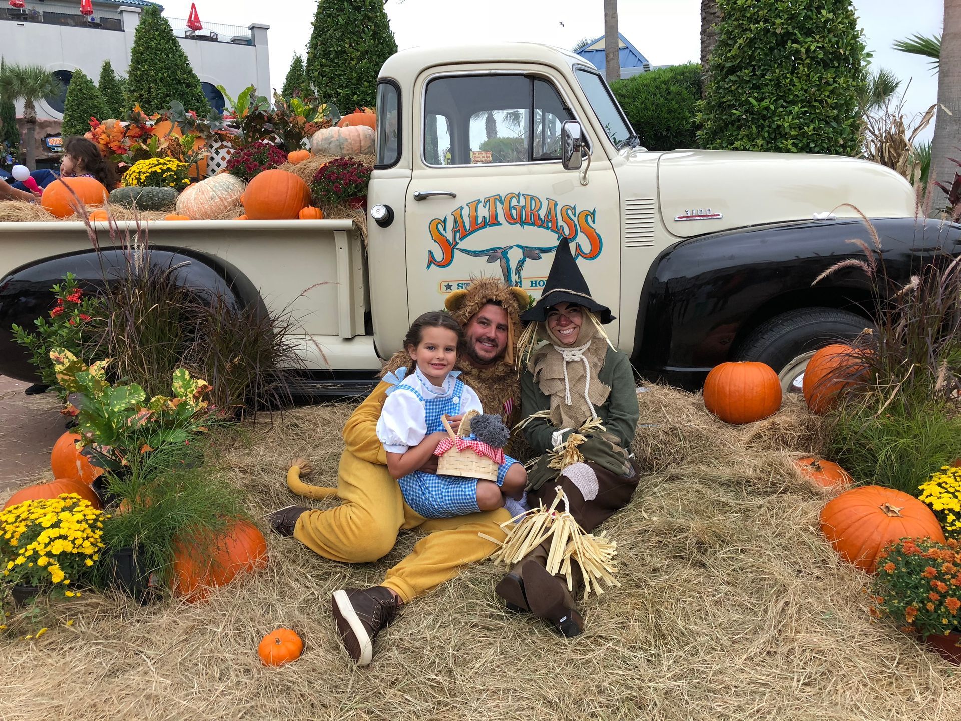 A wizard of oz costume group of people sitting in front of a truck 