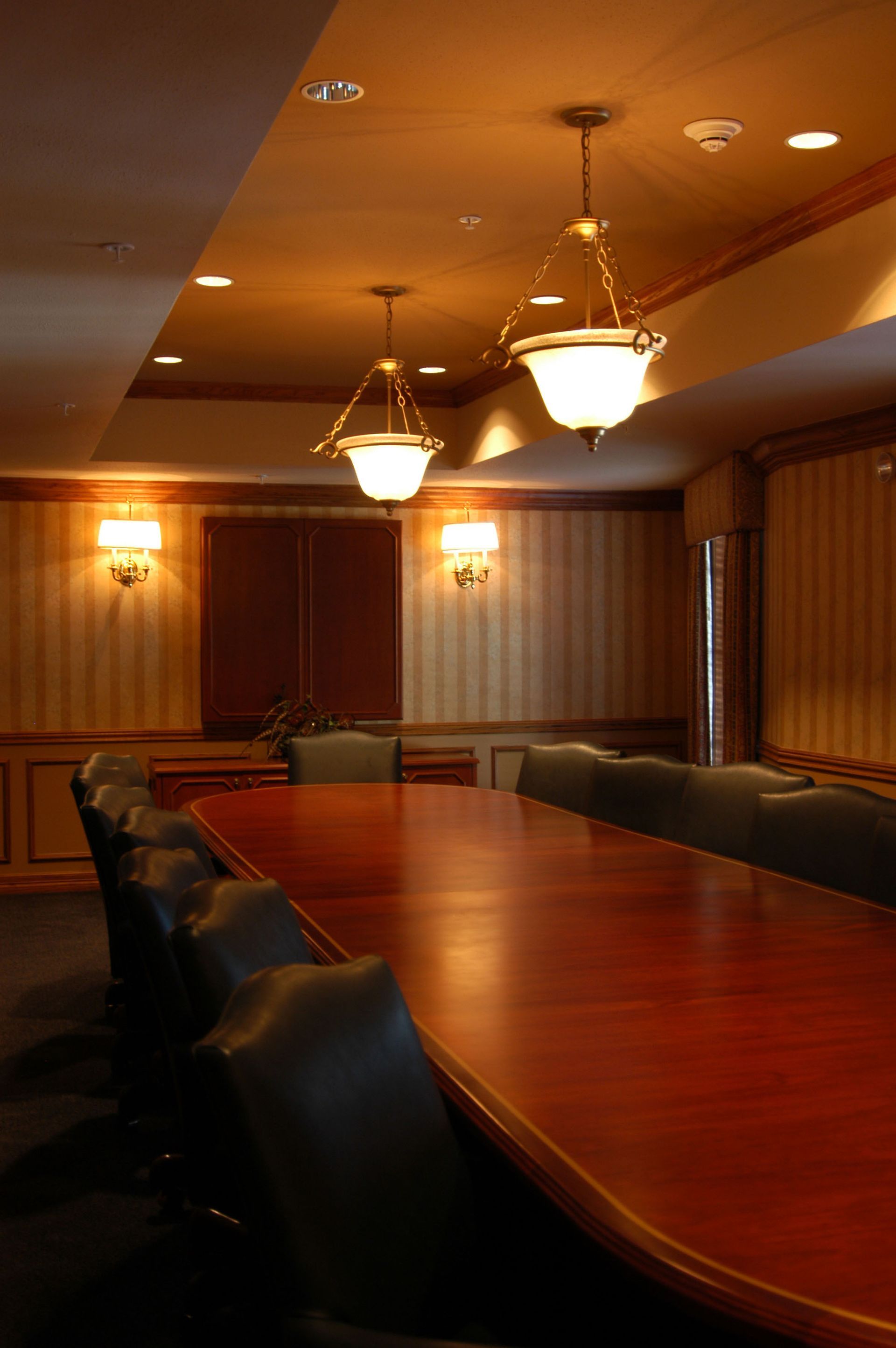 A conference room with a long table and chairs