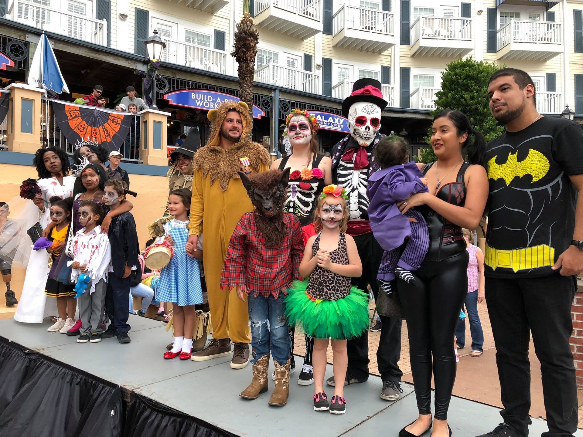 A group of people dressed in halloween costumes are posing for a picture