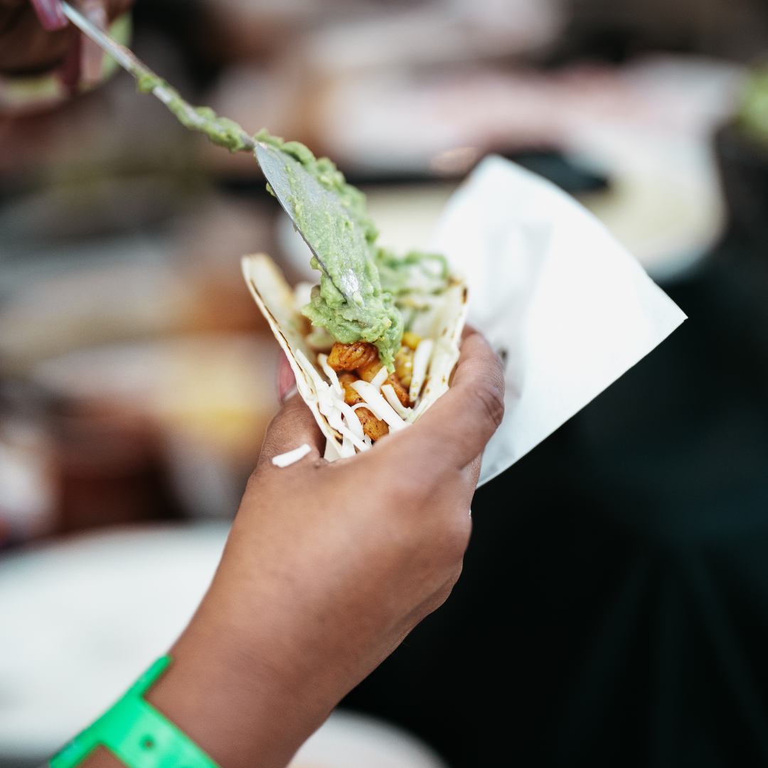 A man and woman are hugging and laughing while a man takes a picture