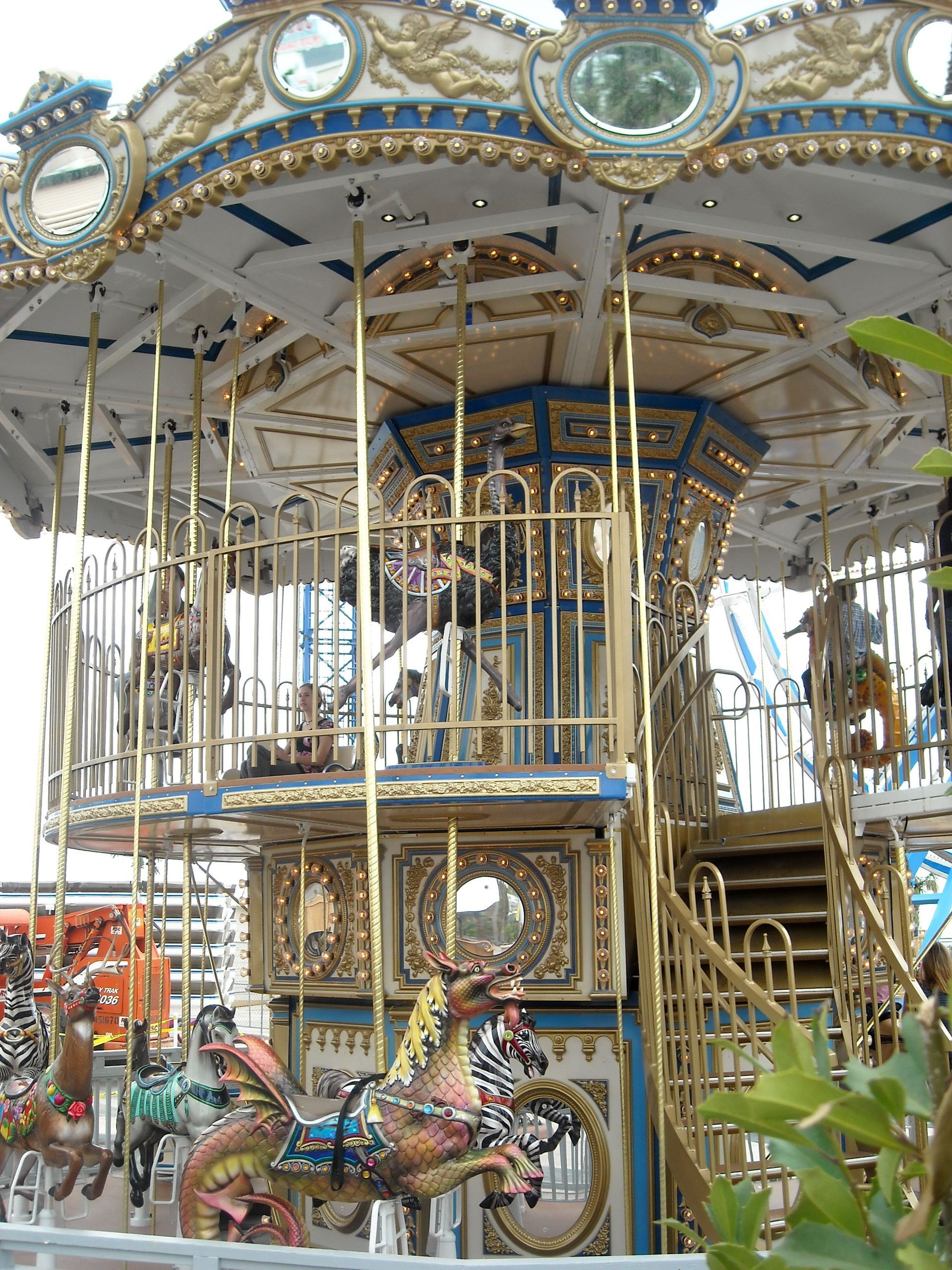 A merry go round with horses and a dragon on it