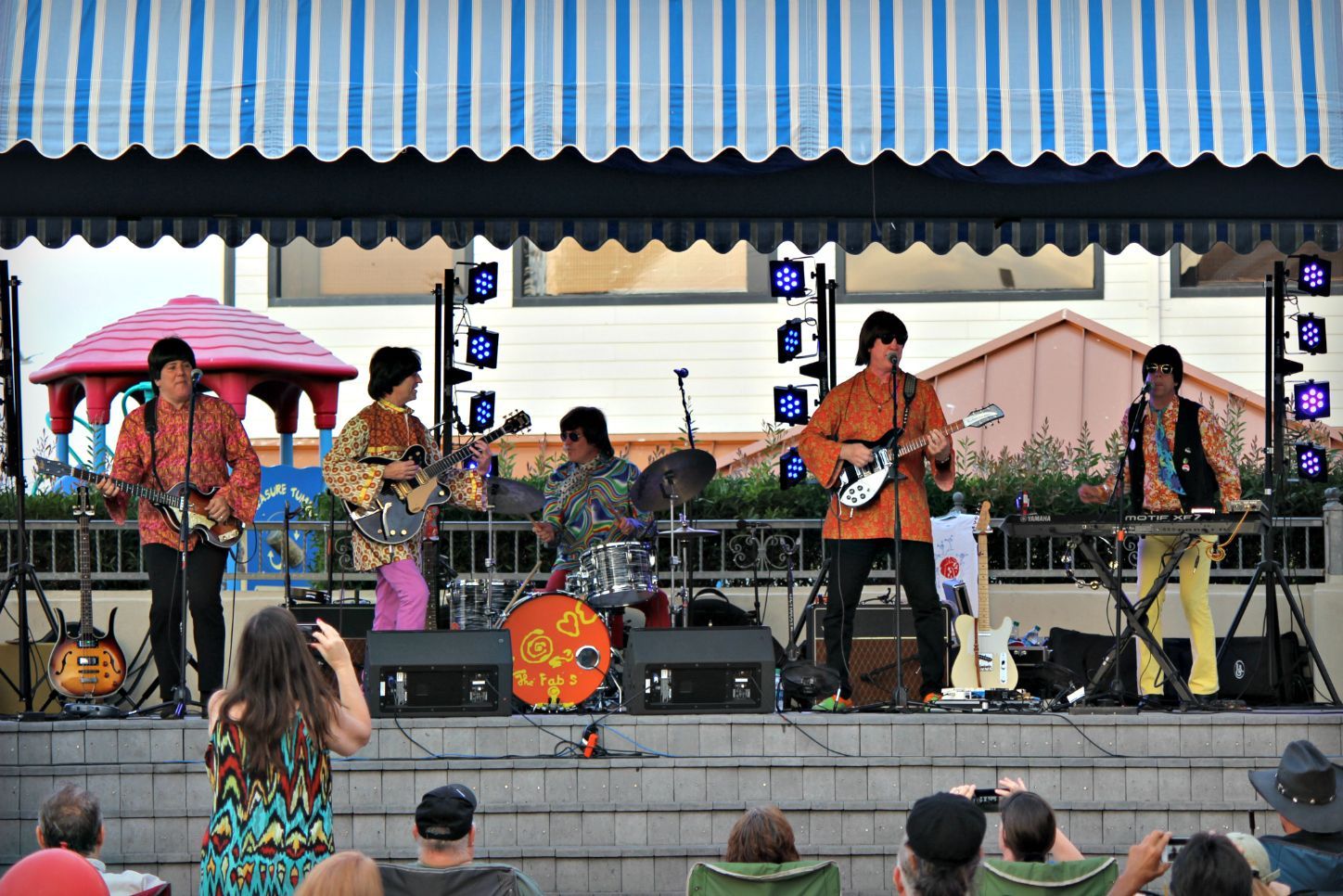 A group of people are playing instruments on a stage
