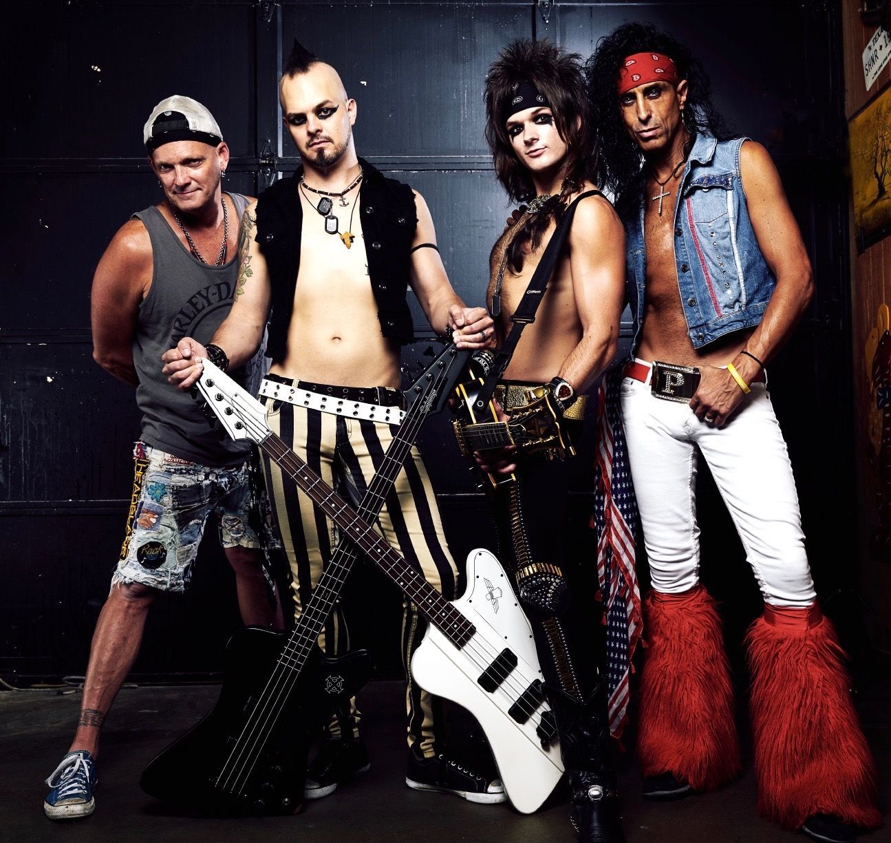A group of men standing next to each other holding guitars