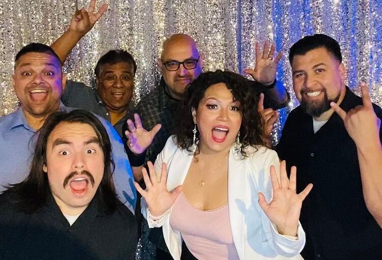 A group of people are posing for a picture in a photo booth.