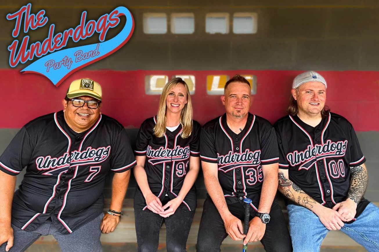 A man in a cowboy hat is playing an acoustic guitar