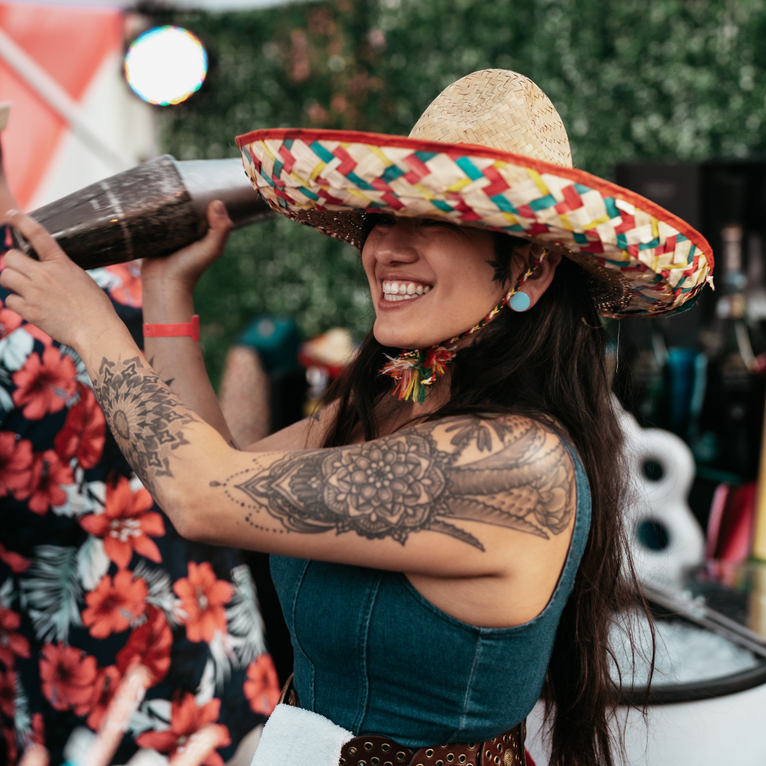 A man and a woman are posing for a picture while holding wine glasses