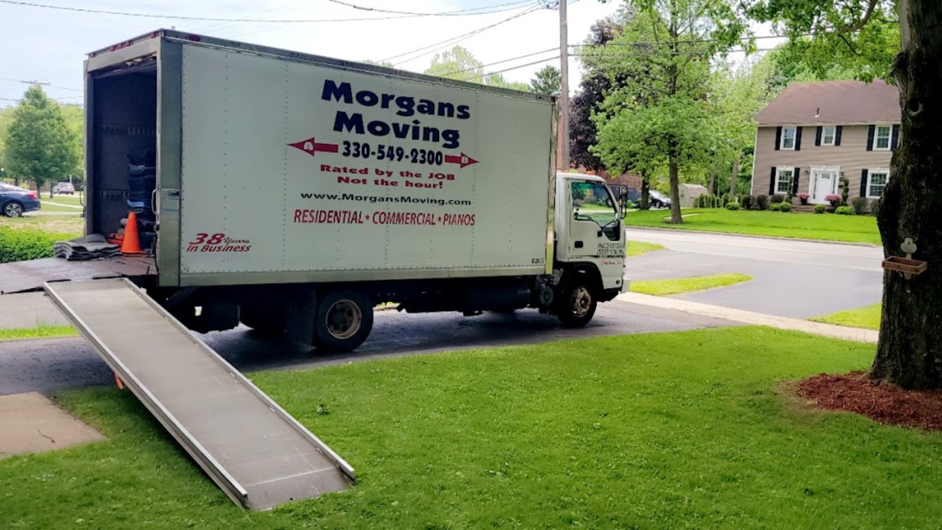A morgans moving truck is parked on the side of the road