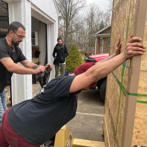 A man is leaning against a wall with his arms outstretched