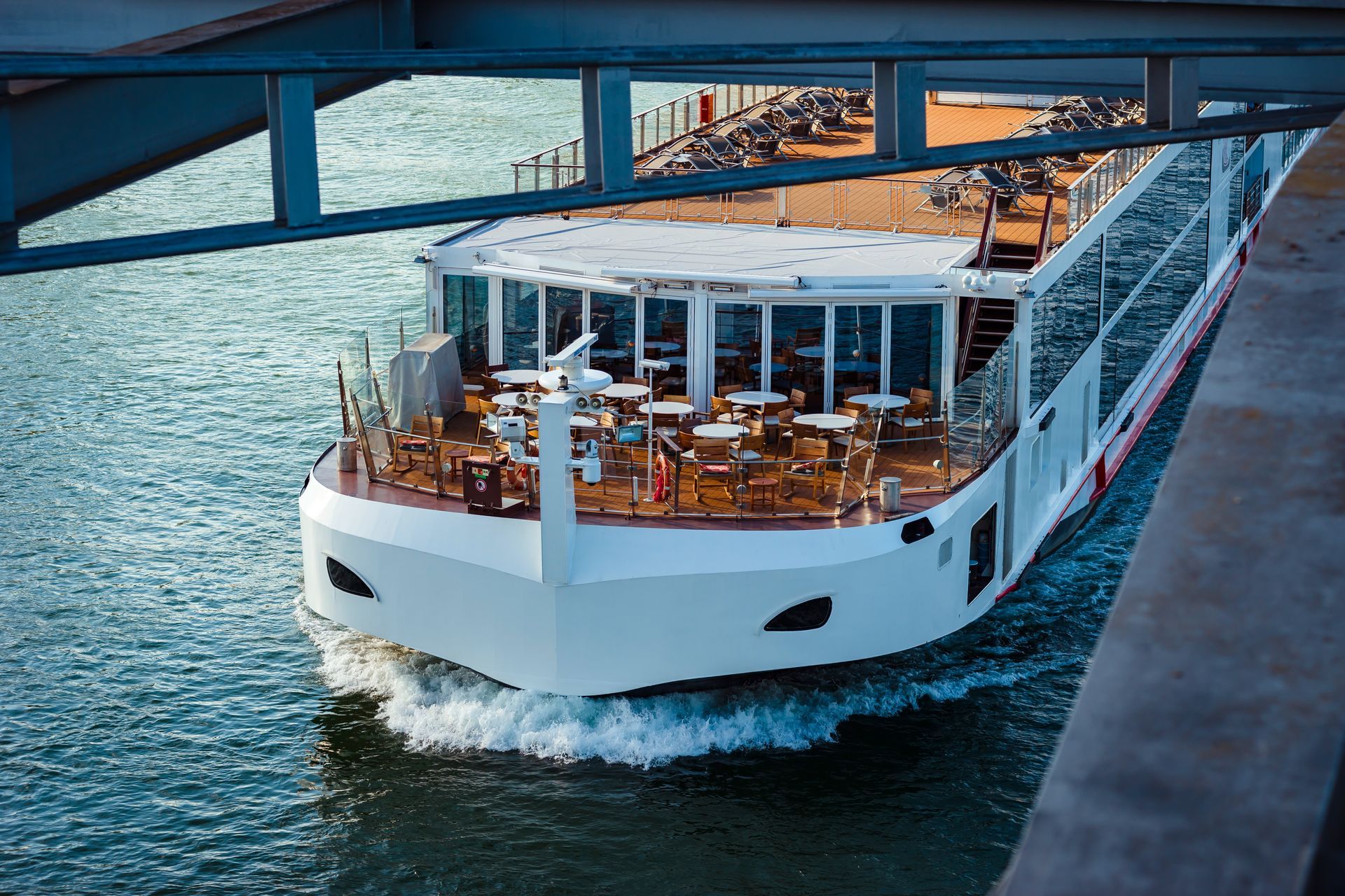 Closeup of the upper part of the front of a river cruise as it sails on the water.