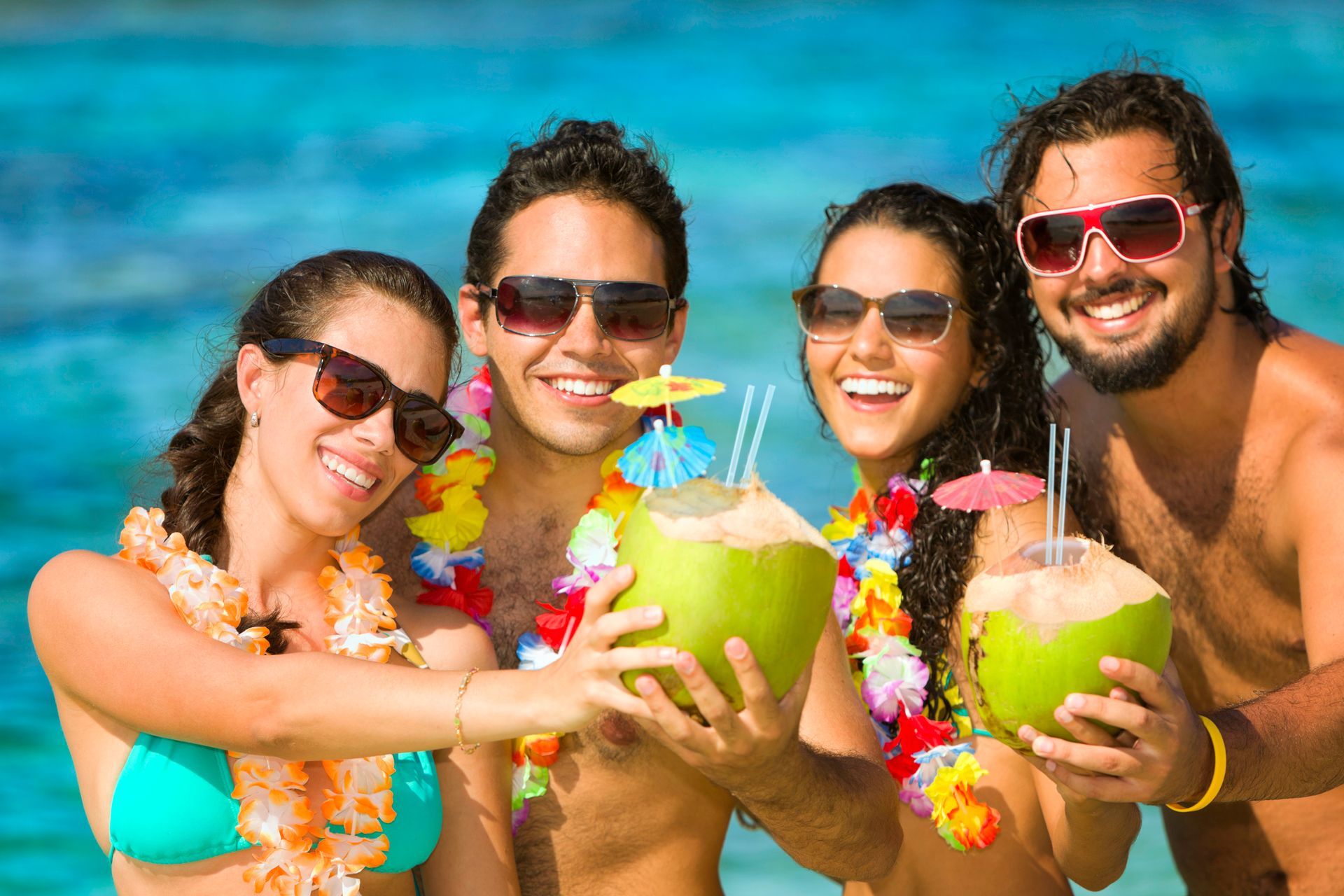 A man paddleboarding in front of a large cruise ship in a bay surrounded by lush mountains.