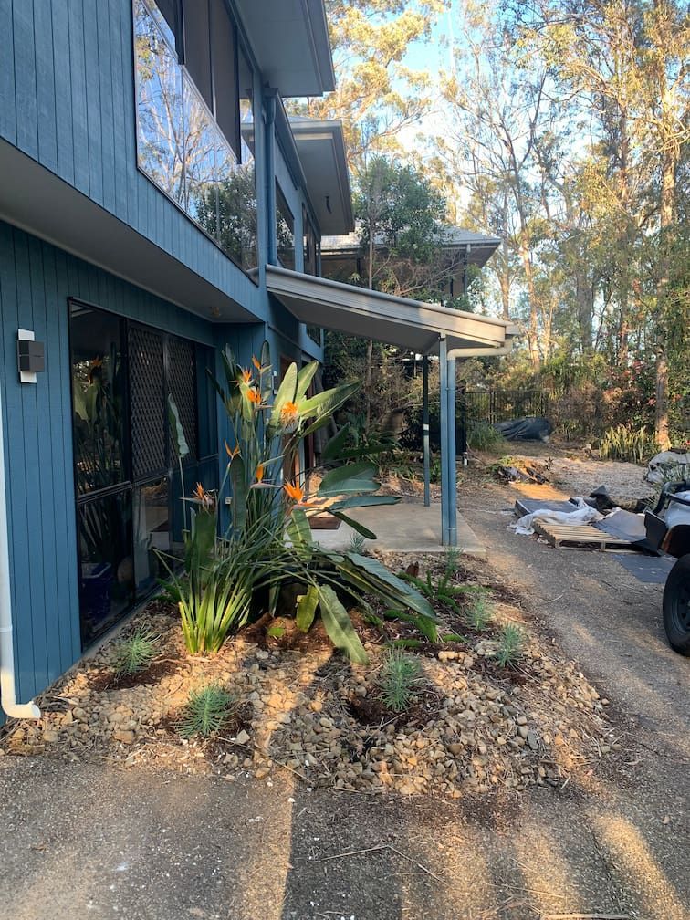 A blue house with a jeep parked in front of it.
