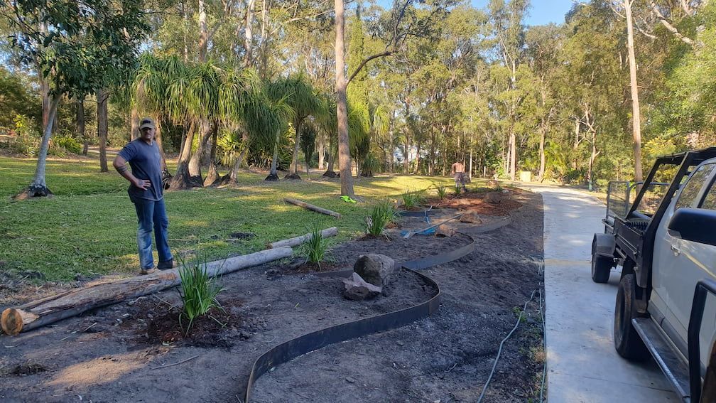 A man is standing in a garden next to a jeep.