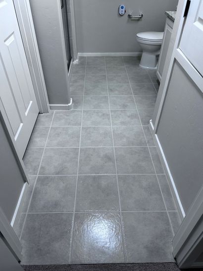 Side-by-side shower grab bar before and after, showing a lower, more accessible placement.