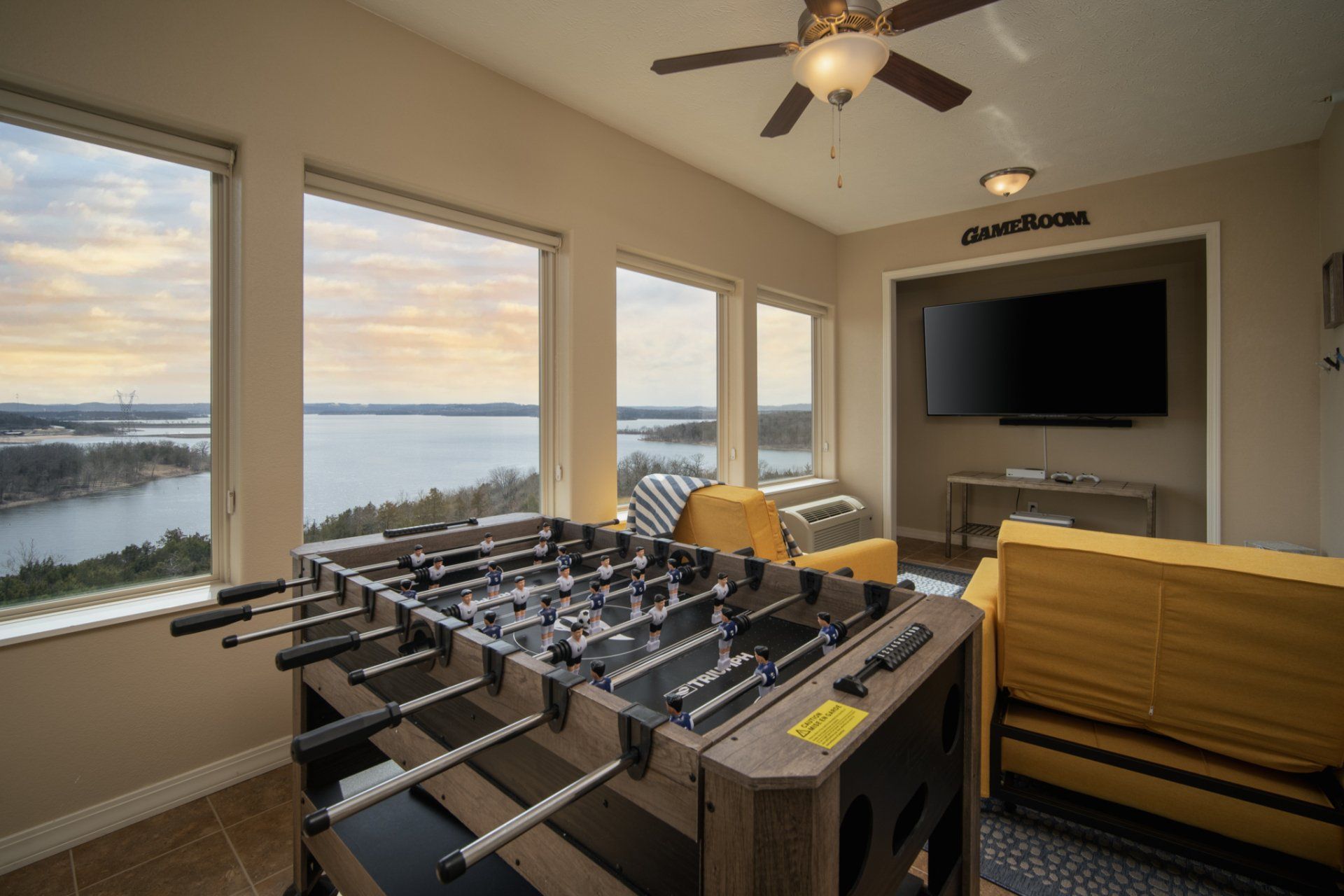 Game room in a short-term rental property with a foosball table and a video game system.