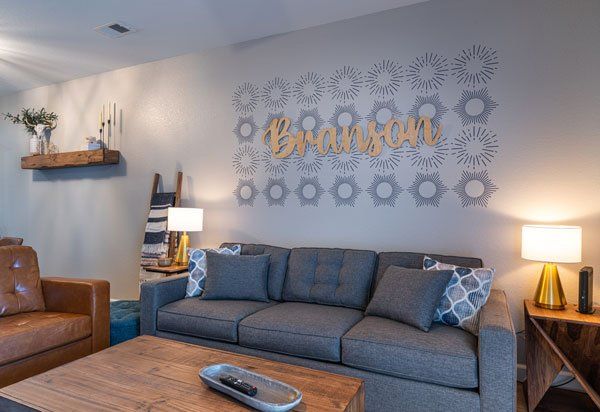 A short term rental property where the interior designer installed a focal wall featuring the word, 