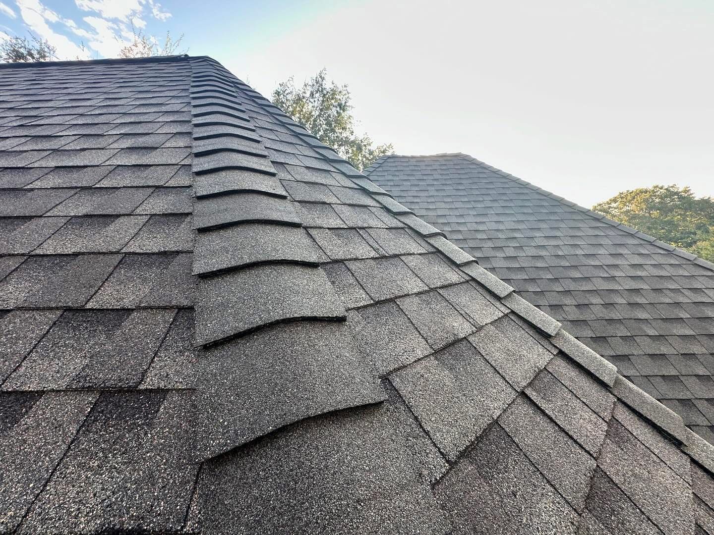 An aerial view of a house with a large roof and a chimney.
