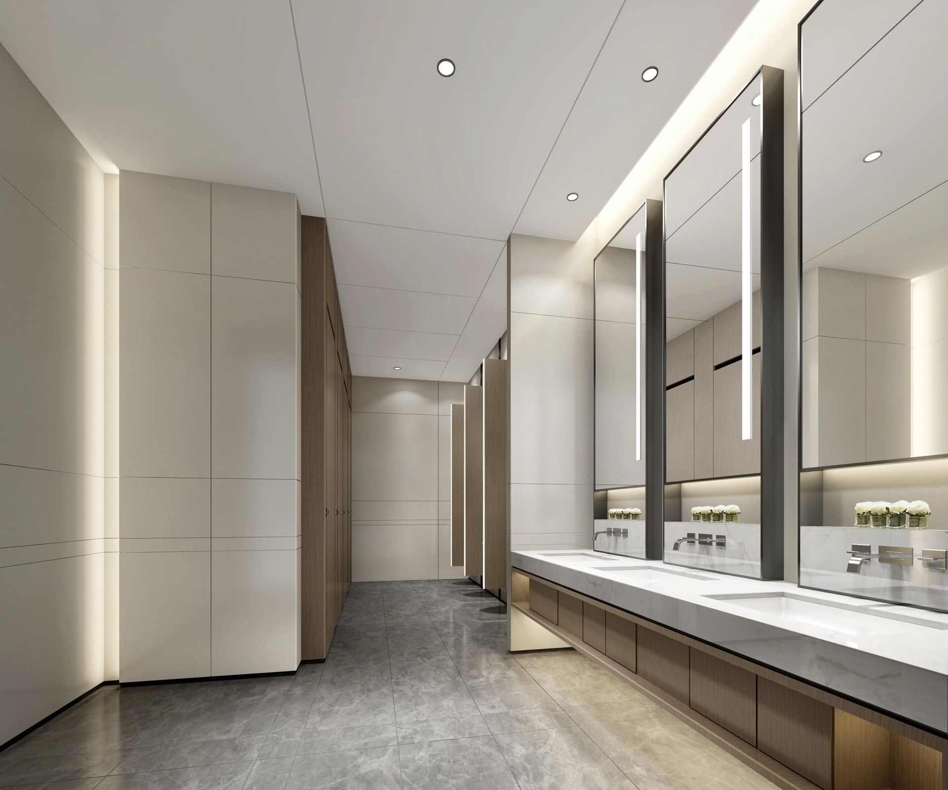 Modern public restroom with marble floor, long vanity, and stalls. Large mirrors reflect the space.