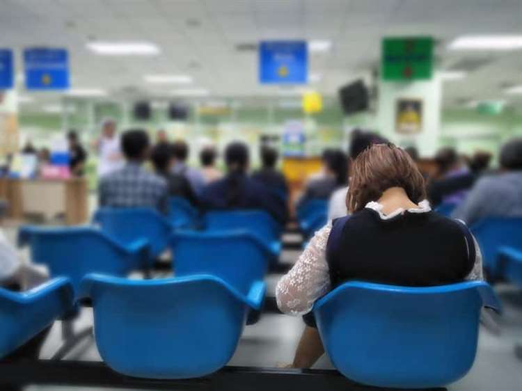 Women sitting in a hospital waiting room with other people