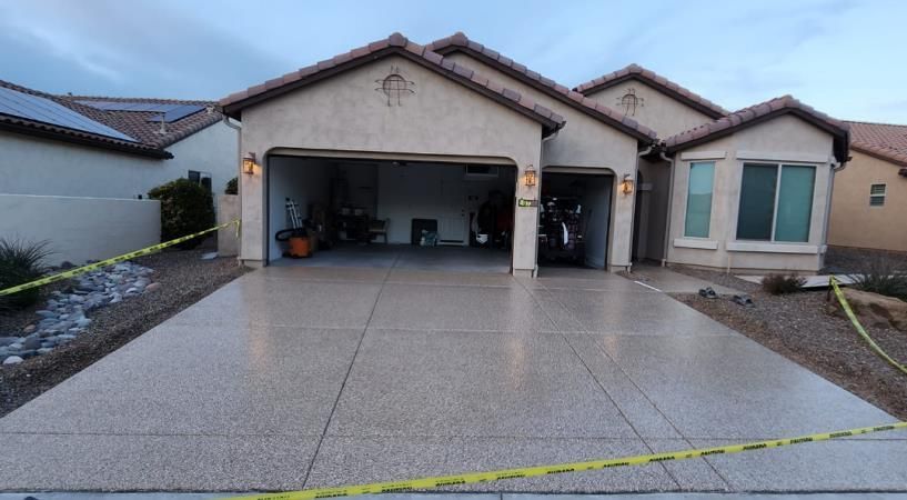 A large house with a concrete driveway in front of it.