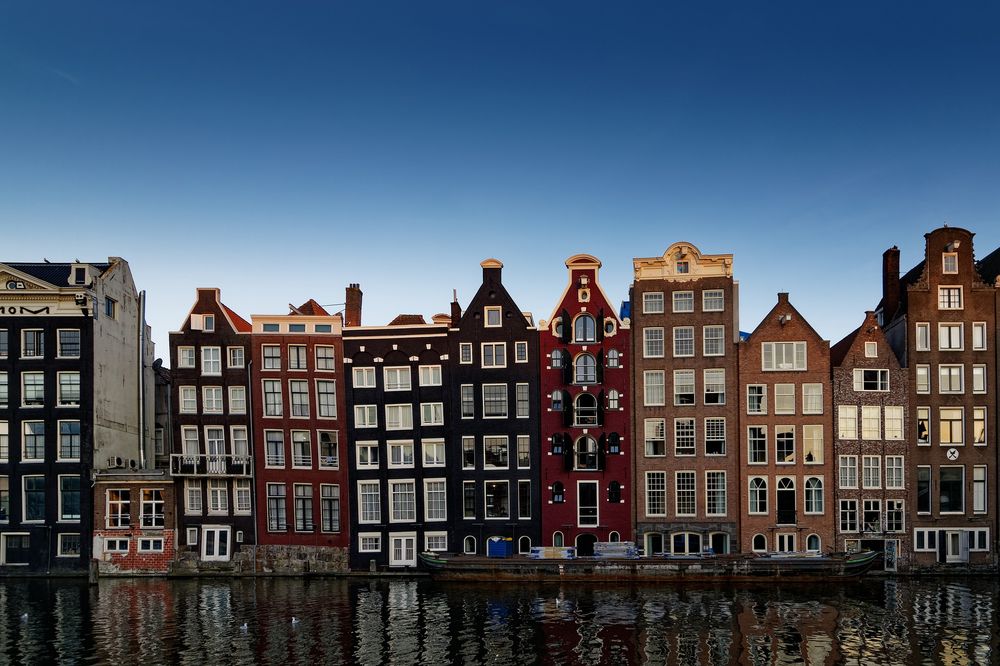 A row of buildings next to a canal in Amsterdam