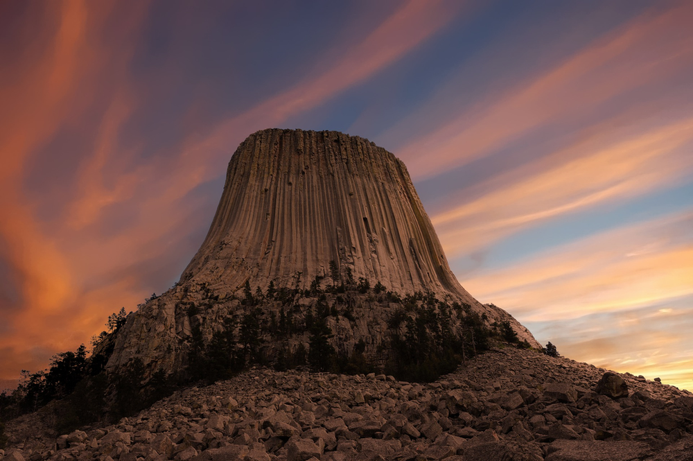 Devils tower rock formation in Wyoming at sunset.