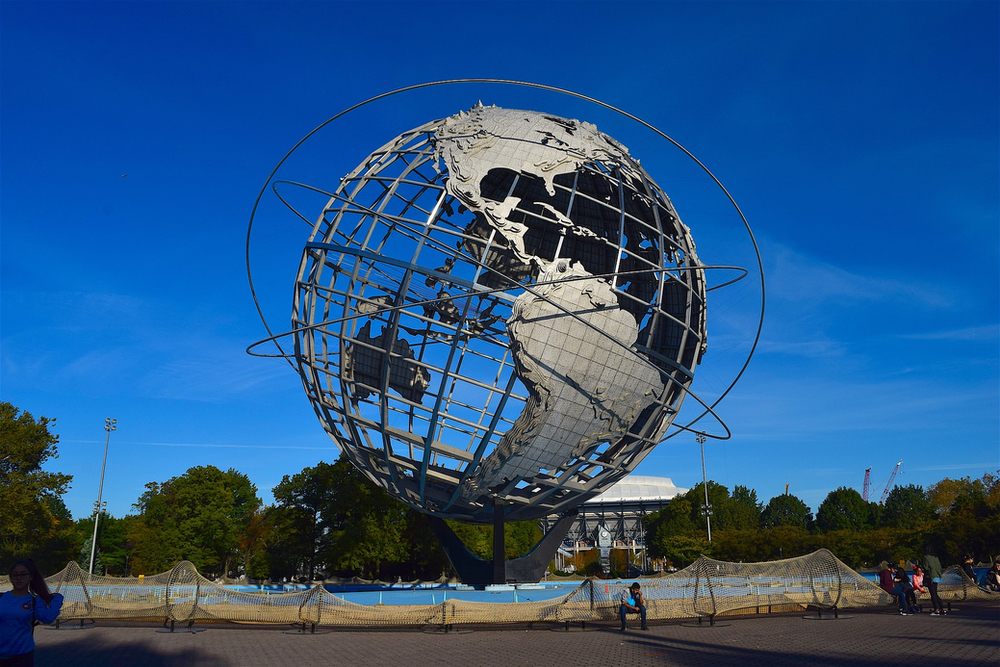 A large metal globe is sitting in the middle of Flushing Meadows park in Queens, New York City