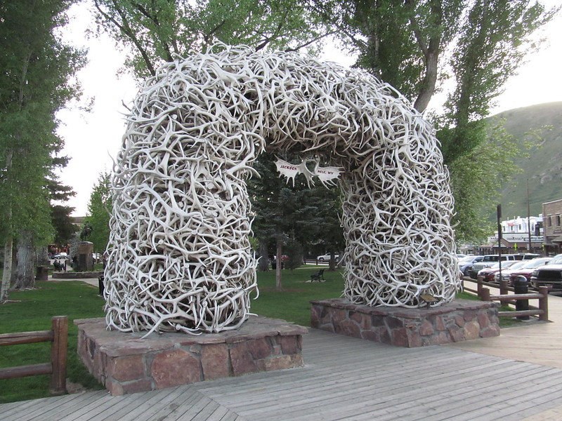 A large arch made of elk antlers in a park in Jackson, wyoming