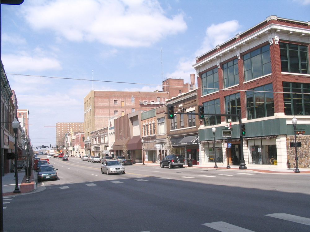Cars are driving down a street in the  small town of joplin