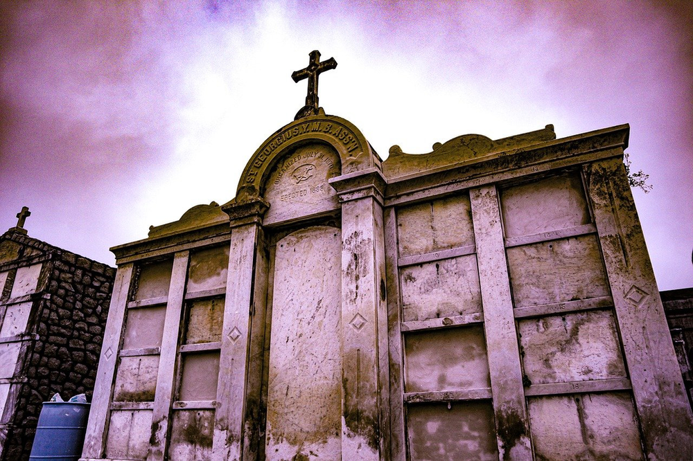 A new orleans cemetery with a cross on top of it