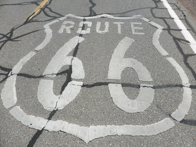 A cracked road with route 66 painted on it