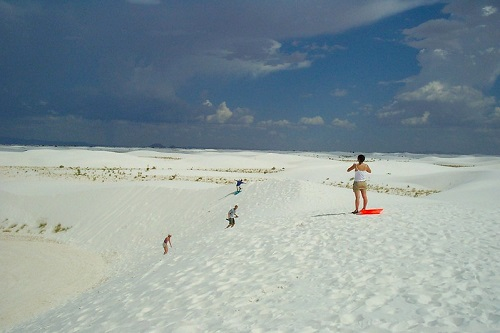 A person standing on a white sandy beach in white sands national park